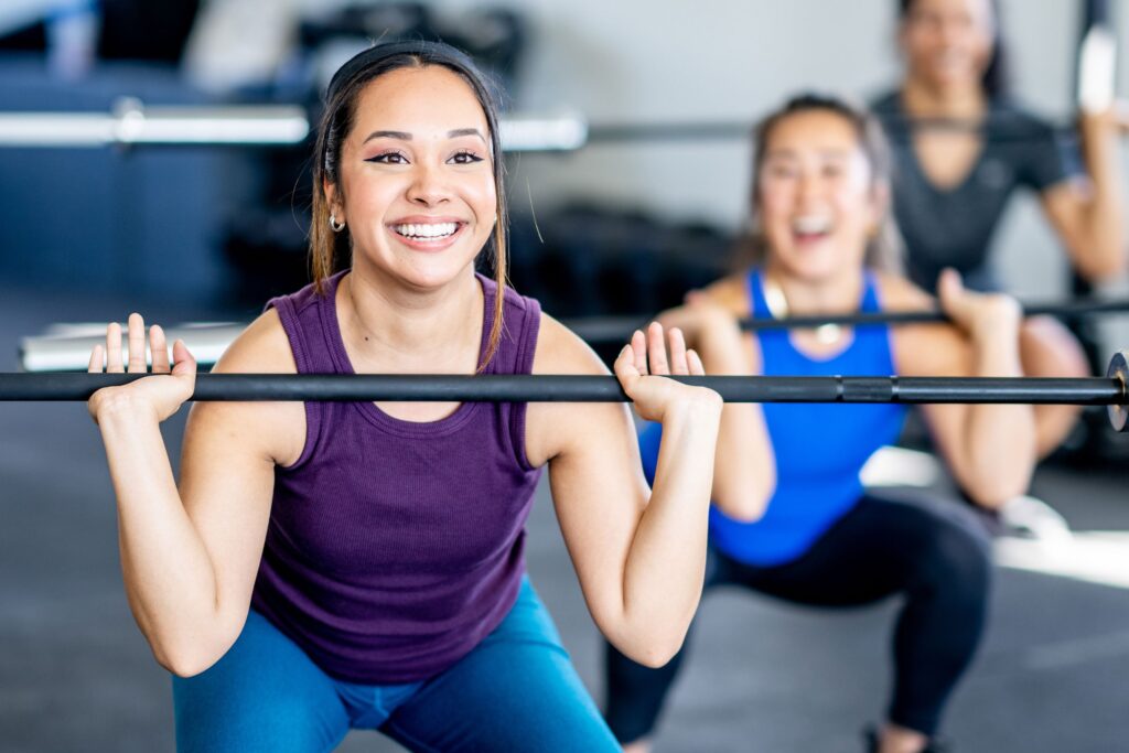 Class exercising with barbells